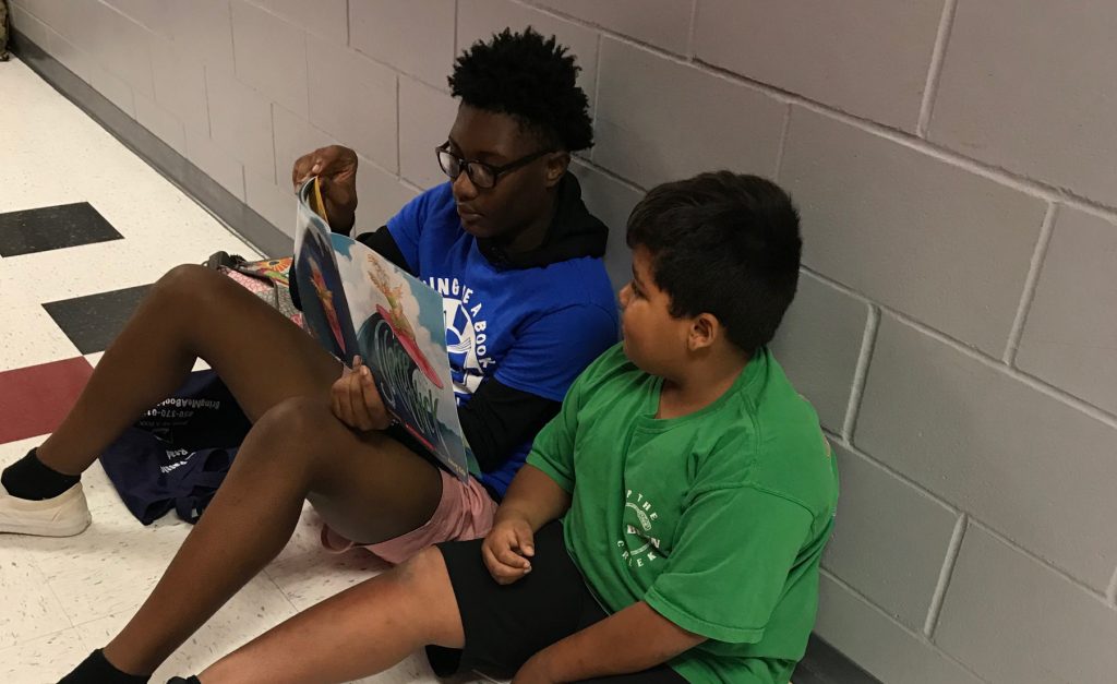2 students reading to one another